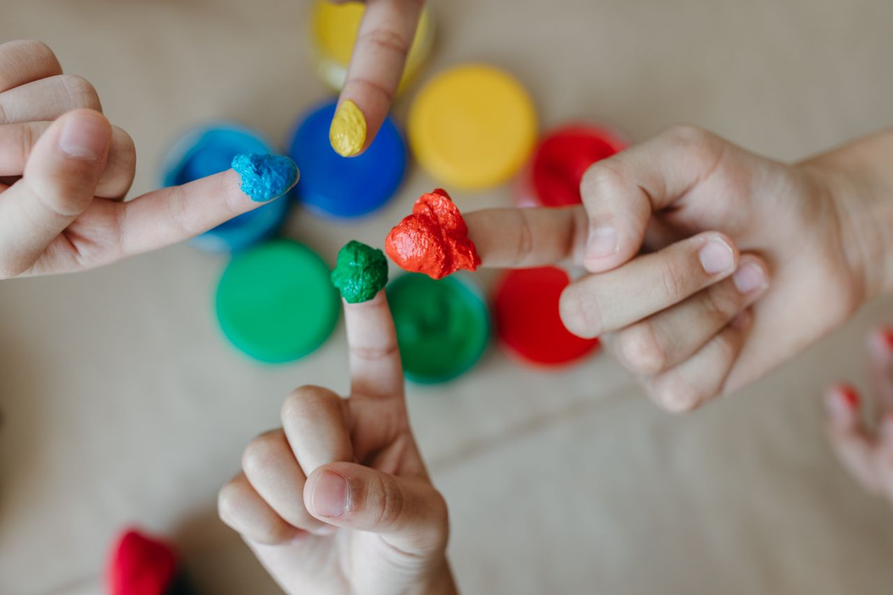 The Art of Drawing Readers In: Your attractive post title goes here Children exploring creativity with colorful finger painting. Close-up of hands and paint.